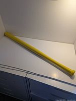 Full view of yellow Wiffle bat