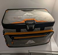 Closed cooler showing top lid, logo, front pocket