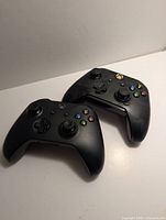 Both Xbox controllers front view showing button layout