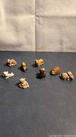 Group shot of all eight animal figurines on tabletop