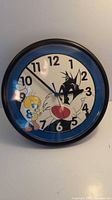 Front view showing full clock face with Tweety and Sylvester graphic and numerals