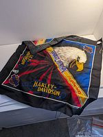 Full view of folded Harley-Davidson cloth banner showing eagle graphic and logos