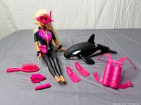 Full set laid out showing Barbie, whale, accessories