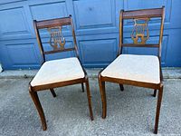 Front view of both harp back chairs showing overall design and condition
