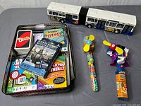 Overview of all items: card games in tin, friction bus, two candy fans
