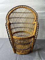 Front view of woven wicker plant stand showing overall shape and lattice pattern