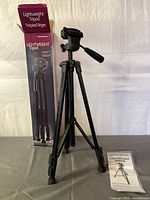 Tripod fully extended with box and manual visible