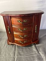 Front view of closed wooden jewelry box