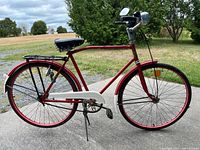 Left side view showing entire bicycle with rear rack, fenders, mirror, headlight, chain guard, kickstand