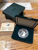 Coin in open velvet case with outer box and card