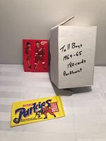 Box marked Tall Boys 1964-65 180 cards Parkhurst, red sample card visible, empty wrapper foreground