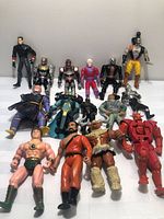 Overall group shot of 15 action figures laid out in three rows