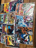 Group shot of all 14 bagged comics spread on table