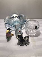 Group shot showing blue ruffled dish, Fenton bear, Waterford votive, ceramic crow and dog figurines