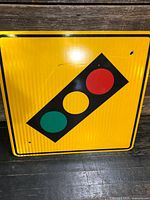 Front of yellow traffic signal warning sign