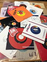 Stack of 7-inch singles in assorted company sleeves