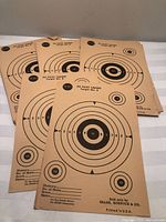 Front view of stacked target sheets showing main bullseye design