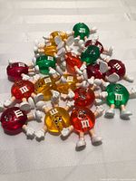 Pile of assorted M&M light toppers showing quantity and colours