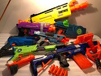 All seven Nerf blasters and two magazines grouped together