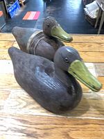 Front angled view of both wooden duck decoys