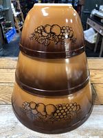 Three Pyrex Old Orchard bowls stacked to show exterior gradient and motif
