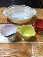 Group shot of casserole with lid and three footed creamers