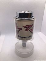 Front view of Panasonic table lighter showing brand name and bird graphics