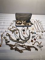 Overview of entire jewelry lot spread on table with open presentation case