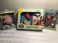 All three sealed Cabbage Patch Kids items grouped together