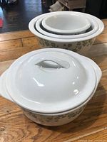 Nested open bowls and covered casserole showing pattern and sizes
