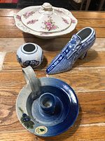 All four ceramic pieces grouped on wooden surface