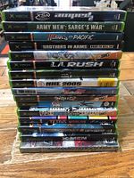 Stack of 16 original Xbox game cases front view