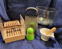 Group shot of bread slicing box, box grater, Butter Boy spreader, trifle bowl, mortar and pestle