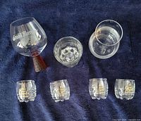 All seven glasses arranged on fabric background