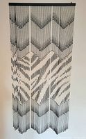 Full view of black and white beaded curtain hanging