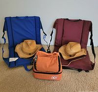 Front view of two cushions, two straw hats, orange cooler