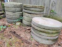 Stacks of circular concrete stepping stones showing quantity and condition