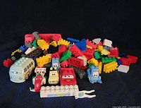 Full lot view showing character vehicles and large pile of Duplo bricks