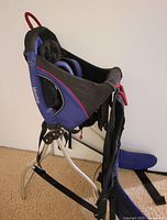 Side view of Kelty Kids Meadow child carrier showing aluminum frame and kickstand