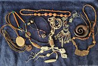 All ten necklaces laid out on dark fabric