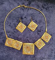 Entire jewellery set laid out showing necklace and earrings