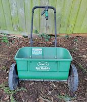 Front view of Scotts Turf Builder Classic Drop spreader showing hopper, wheels, handle