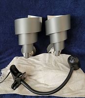 overall view of two silver spiral sconces and black clip lamp