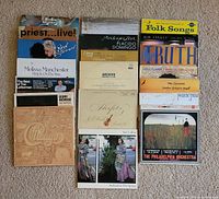 Overview of entire lot showing two vertical stacks of album covers
