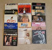 Front view of 15 albums laid out on floor