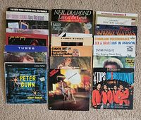 All three stacks of vinyl records displayed on floor