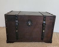 Front view of wood trunk with leather straps and latch