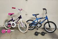 Both bicycles side by side with training wheels displayed
