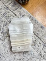 front view of banded onyx ashtray showing shape, banding and wear