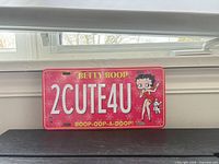 Front view of the pink Betty Boop novelty license plate showing full design and text
